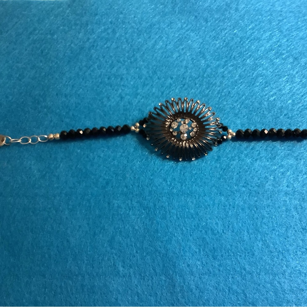 Black metal, beads, and crystal bracelet